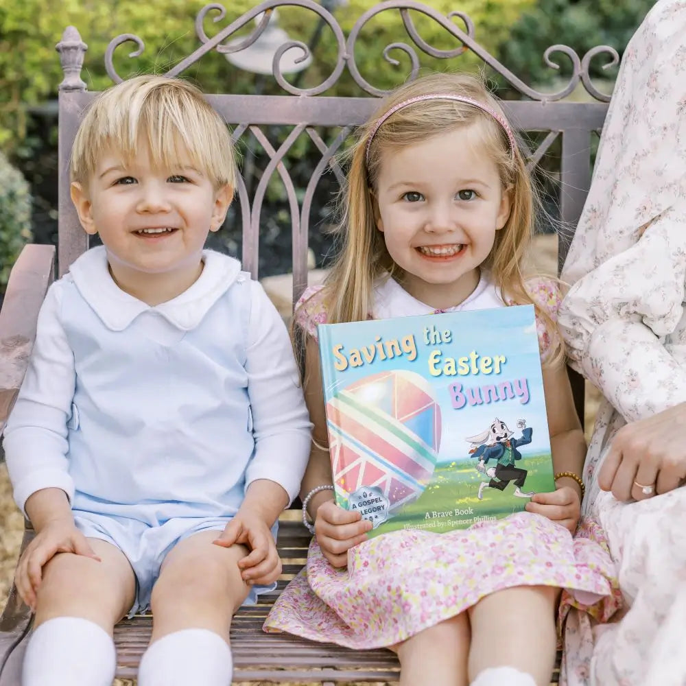 2 little kids holding 'Saving the Easter Bunny', an Easter allegory by BRAVE Books
