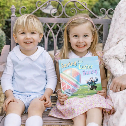 2 little kids holding 'Saving the Easter Bunny', an Easter allegory by BRAVE Books