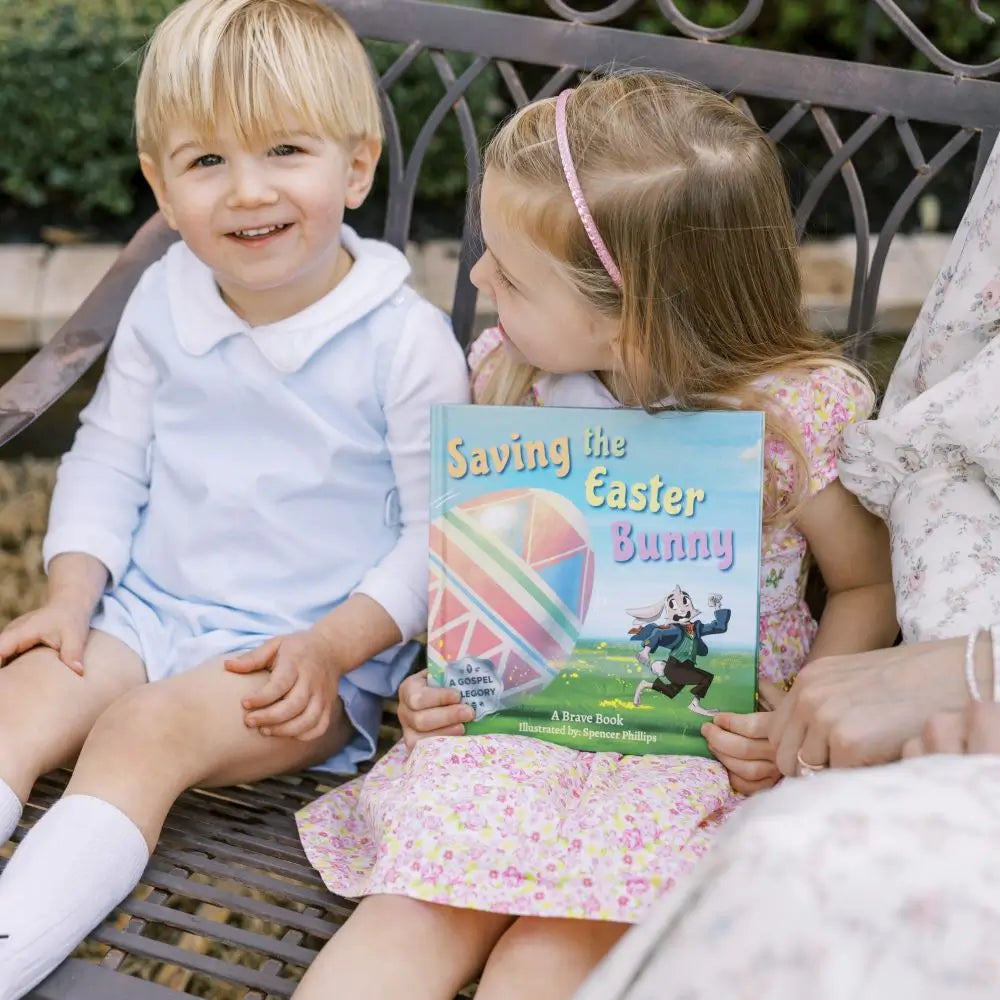 2 little kids holding 'Saving the Easter Bunny', an Easter allegory by BRAVE Books